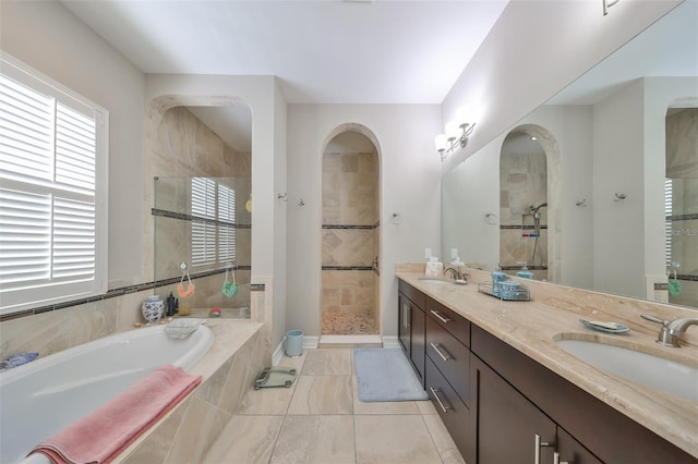 bathroom featuring tile patterned flooring, vanity, a healthy amount of sunlight, and shower with separate bathtub