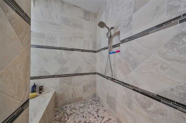 bathroom featuring a tile shower