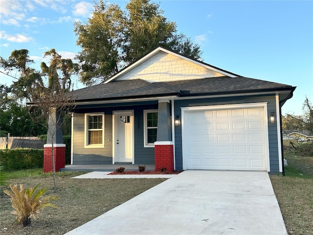 view of front of property featuring covered porch and a garage