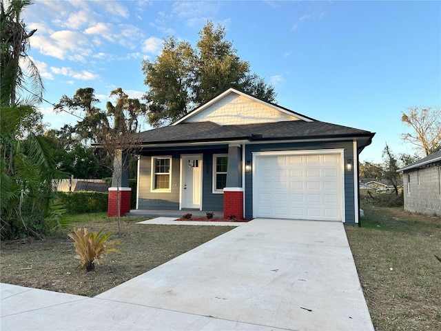 3208 Deleuil Ave, Tampa, FL 33610 - view of front of property featuring a garage, covered porch, concrete driveway, and roof with shingles