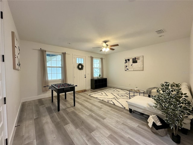3208 Deleuil Ave, Tampa, FL 33610 - living area with light wood-type flooring, baseboards, and ceiling fan