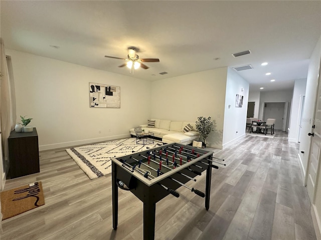 game room featuring wood-type flooring and ceiling fan