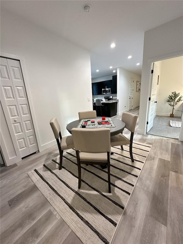 3208 Deleuil Ave, Tampa, FL 33610 - dining space with light wood-style floors, baseboards, and recessed lighting