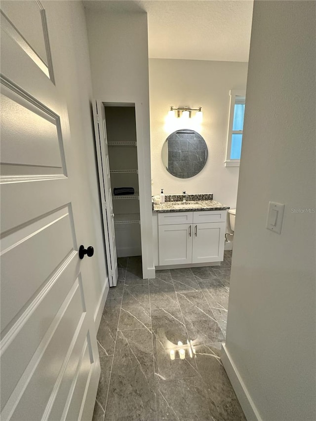 3208 Deleuil Ave, Tampa, FL 33610 - bathroom with baseboards, vanity, and toilet