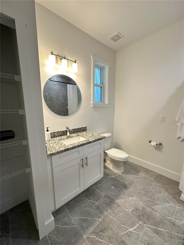 3208 Deleuil Ave, Tampa, FL 33610 - full bathroom with vanity, baseboards, toilet, a shower with curtain, and a walk in closet