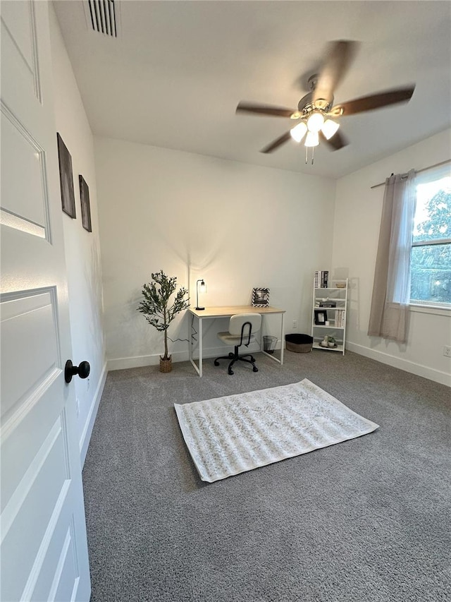 unfurnished office with dark colored carpet and ceiling fan