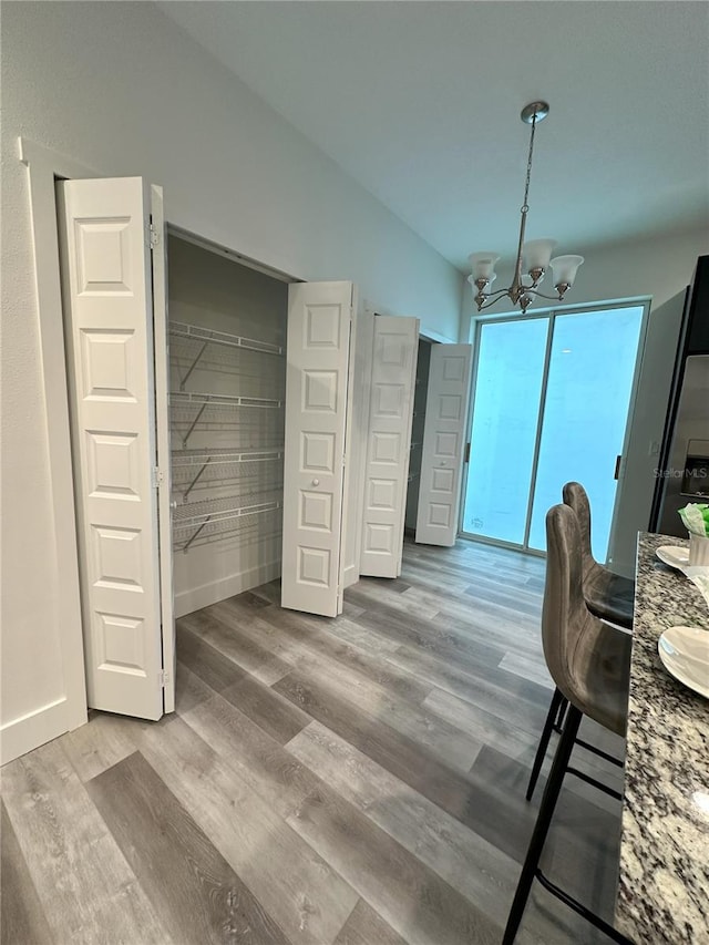3208 Deleuil Ave, Tampa, FL 33610 - dining area featuring a chandelier and wood finished floors