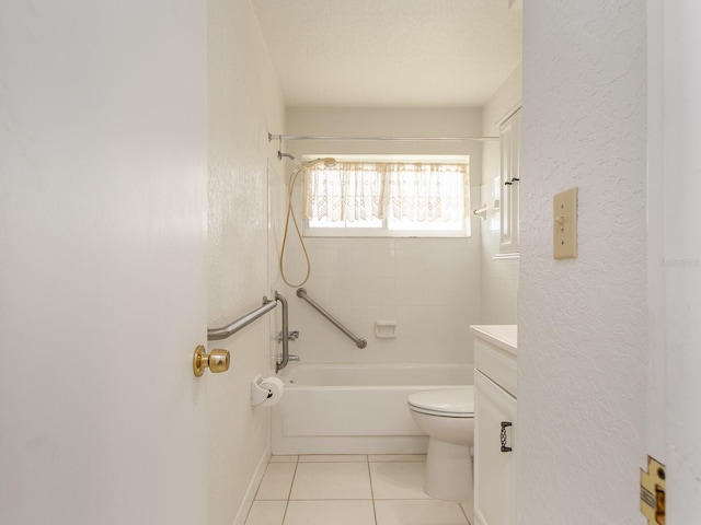 full bathroom with tiled shower / bath, tile patterned floors, vanity, and toilet