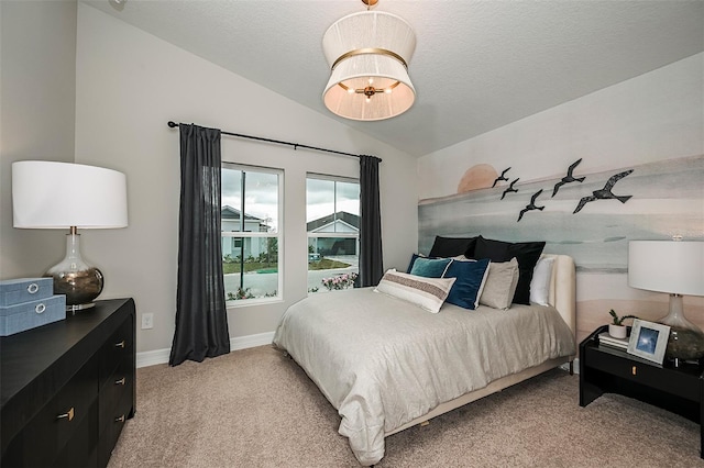 carpeted bedroom with vaulted ceiling and a textured ceiling