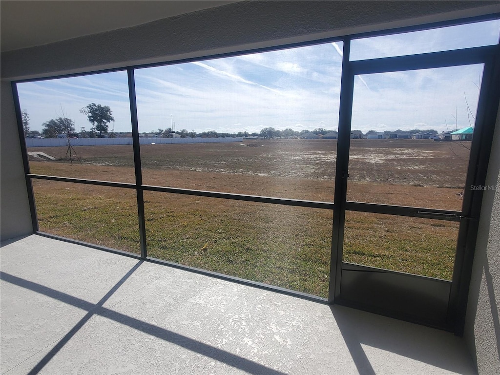 sunroom / solarium with a rural view