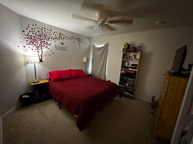 carpeted bedroom featuring a textured ceiling and ceiling fan