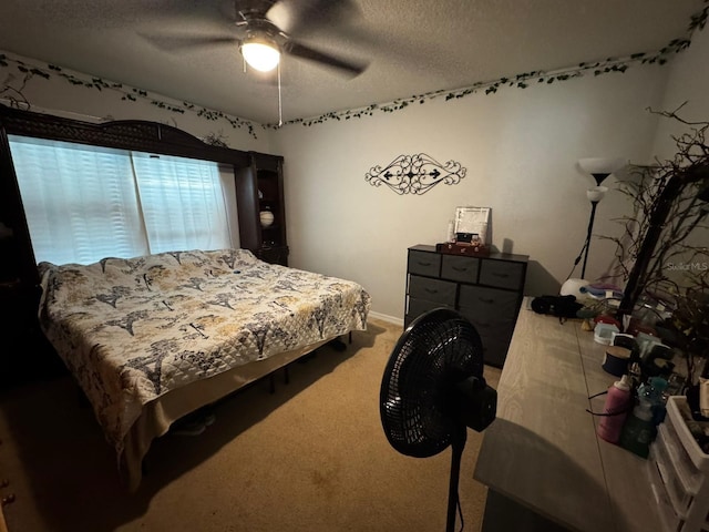 carpeted bedroom featuring a textured ceiling and ceiling fan