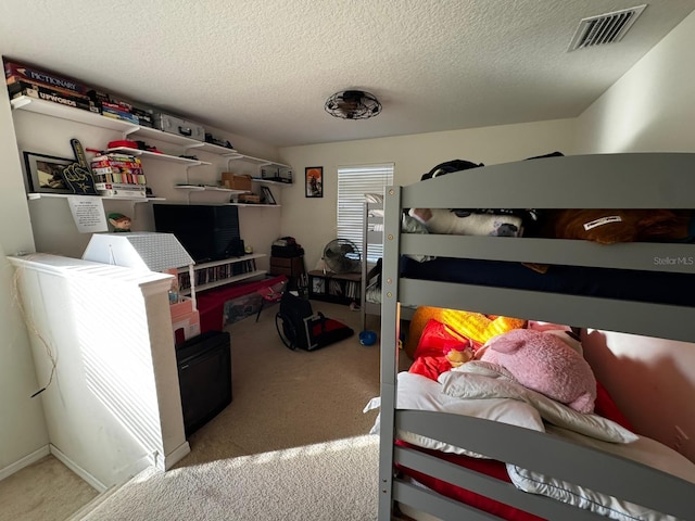 carpeted bedroom featuring a textured ceiling