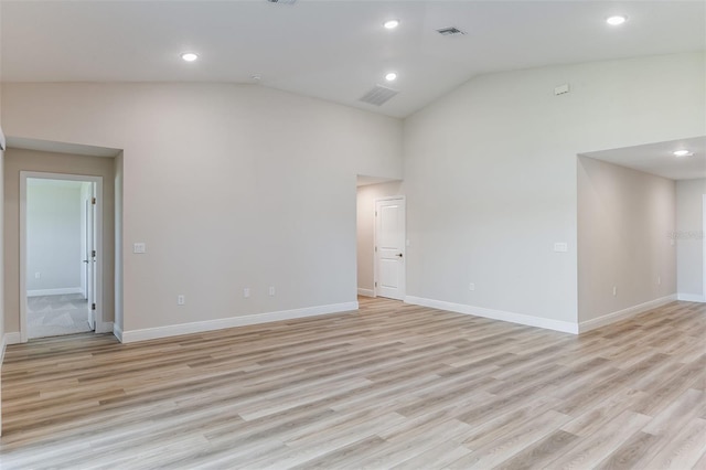 spare room with baseboards, visible vents, and light wood-style floors