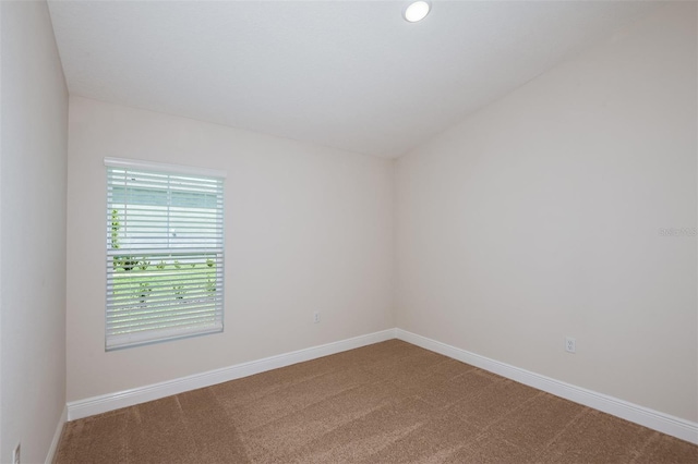 carpeted empty room with lofted ceiling, recessed lighting, and baseboards