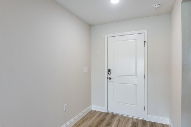 entryway with light wood-style flooring and baseboards