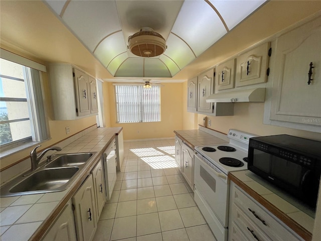 kitchen featuring tile countertops, ceiling fan, sink, and white range with electric cooktop