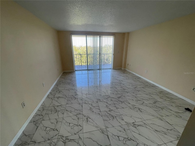 unfurnished room featuring a textured ceiling