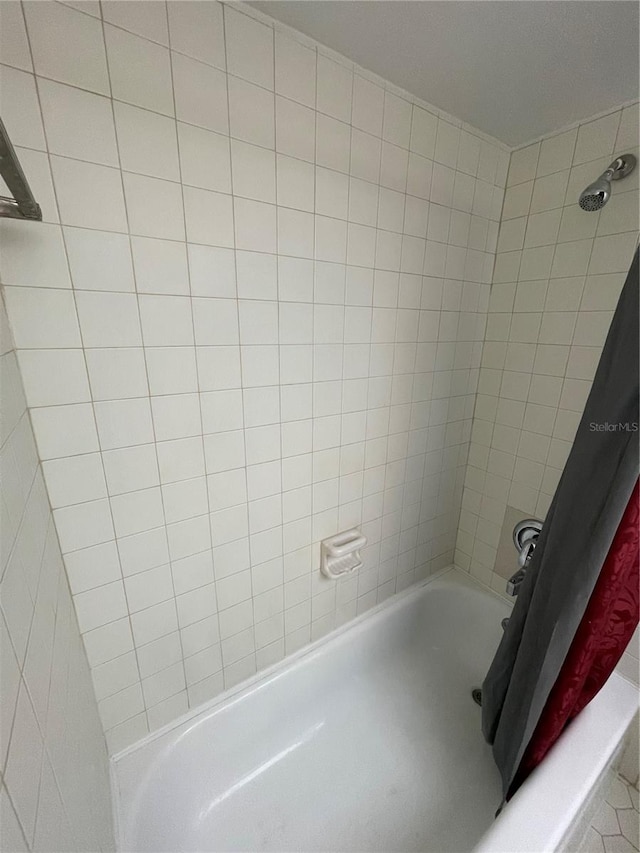 bathroom featuring shower / bathtub combination with curtain