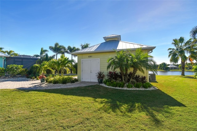 exterior space featuring central air condition unit and a water view