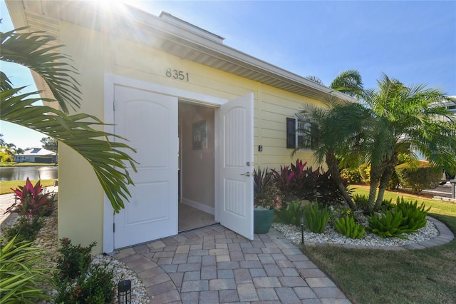 view of exterior entry with a water view