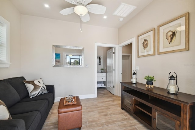 living room featuring ceiling fan and light hardwood / wood-style floors