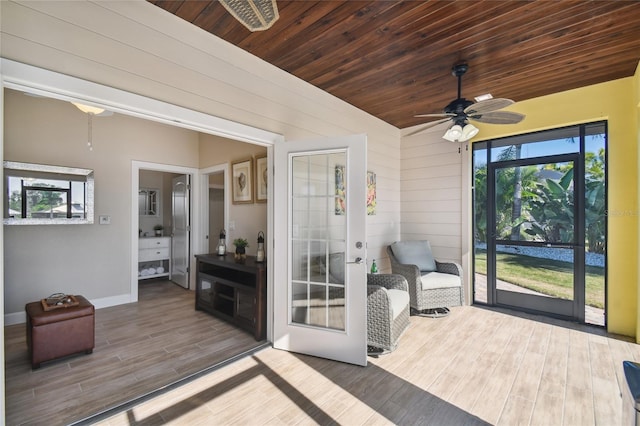 sunroom / solarium featuring ceiling fan and wood ceiling