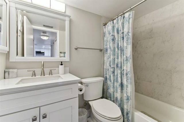 full bathroom featuring vanity, toilet, and shower / bathtub combination with curtain