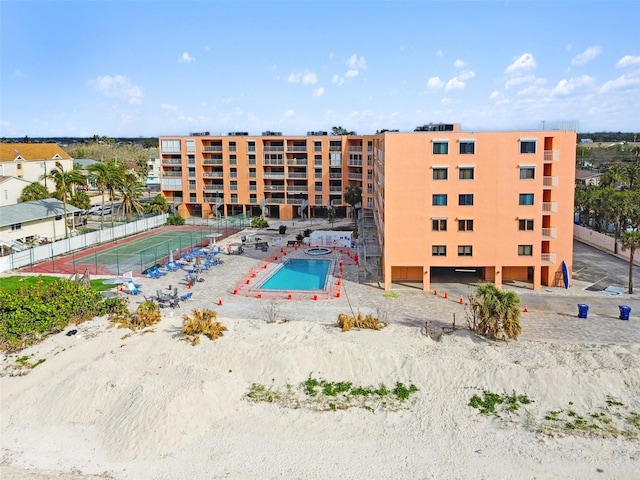 view of building exterior with a community pool