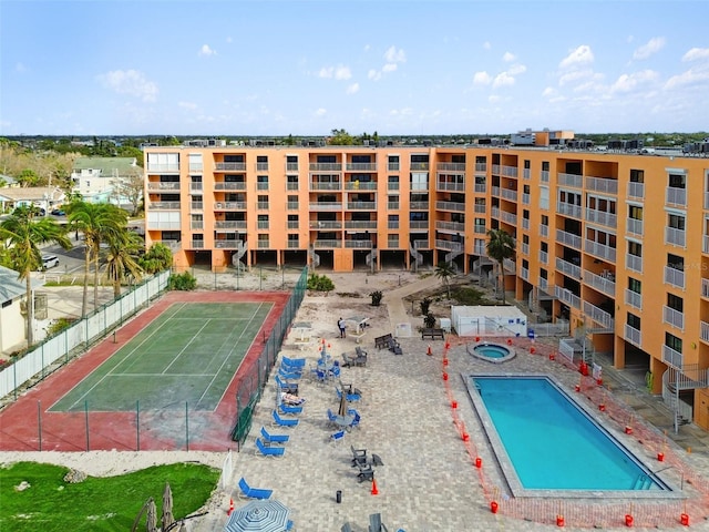 view of swimming pool with tennis court