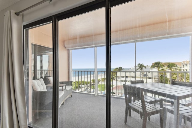 sunroom / solarium with a water view