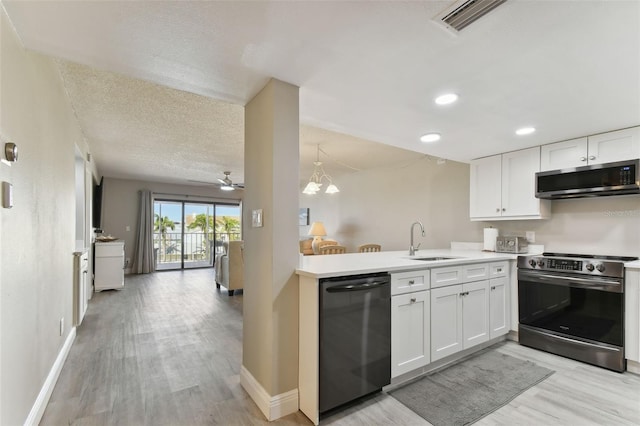 kitchen with light wood-type flooring, white cabinetry, sink, and appliances with stainless steel finishes