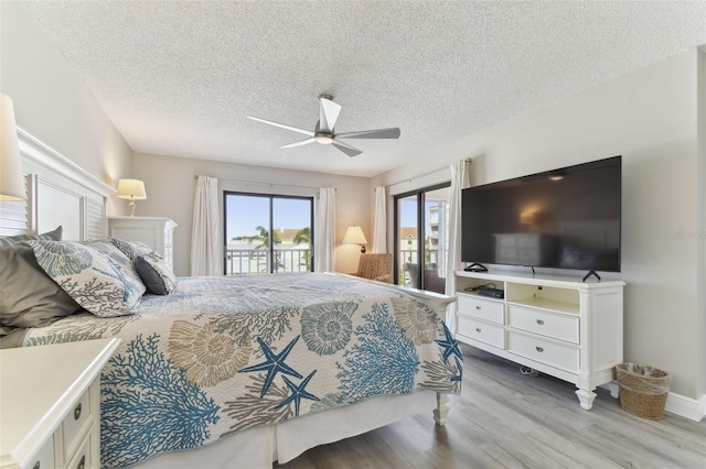 bedroom with access to exterior, ceiling fan, a textured ceiling, and hardwood / wood-style flooring