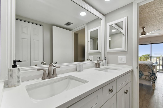 bathroom with vanity, hardwood / wood-style flooring, and ceiling fan