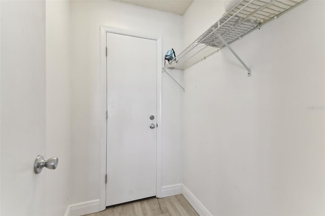 spacious closet with light hardwood / wood-style floors