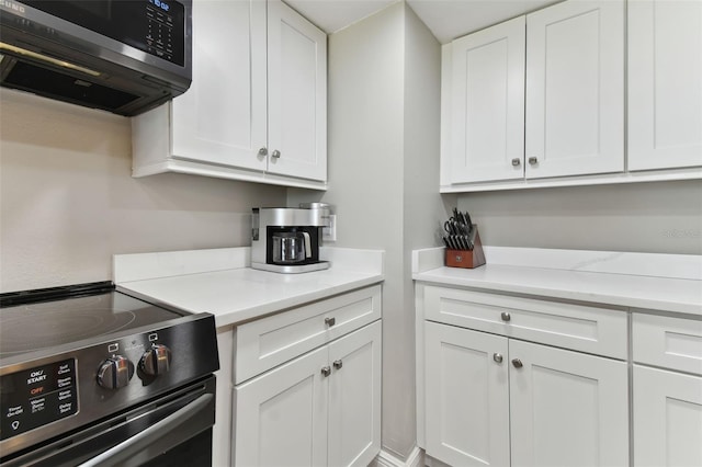 kitchen featuring white cabinets and appliances with stainless steel finishes