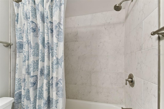 bathroom with toilet and shower / bath combo with shower curtain