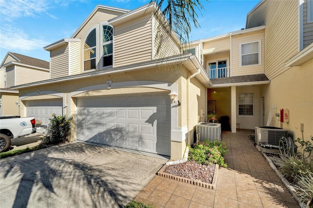 multi unit property with central AC, a balcony, and a garage