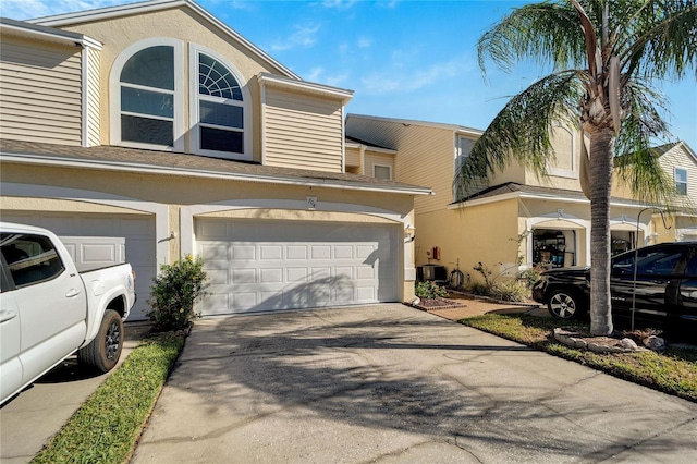 view of front of property with cooling unit and a garage