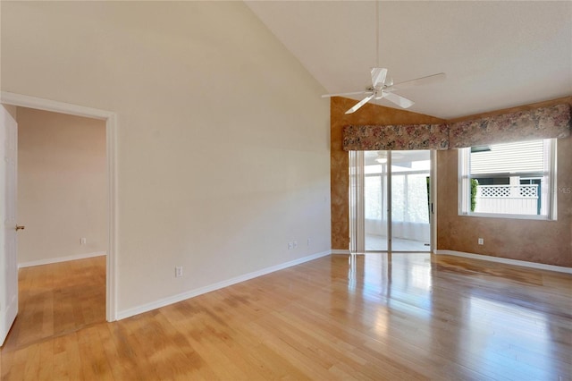 spare room featuring ceiling fan, high vaulted ceiling, and light hardwood / wood-style floors