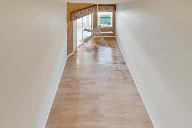 corridor with light hardwood / wood-style floors