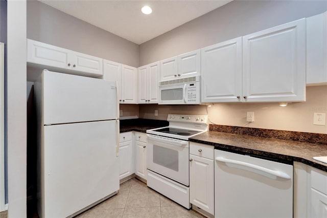 kitchen with white cabinets, white appliances, and light tile patterned floors