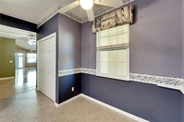 tiled empty room with ceiling fan