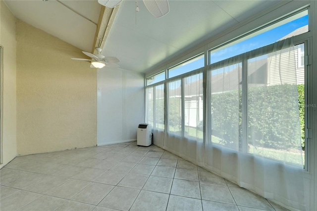 unfurnished sunroom with ceiling fan, a healthy amount of sunlight, and vaulted ceiling