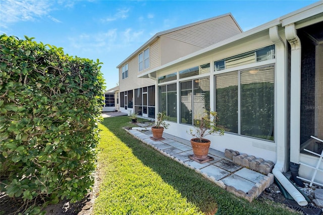 view of yard featuring a sunroom