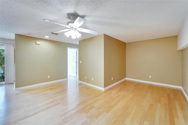 empty room featuring ceiling fan, a textured ceiling, and light hardwood / wood-style flooring