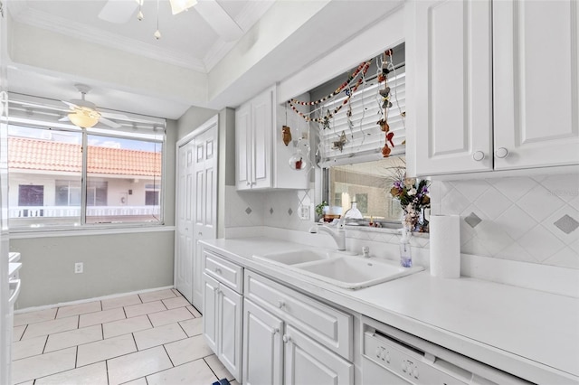 kitchen featuring backsplash, crown molding, white cabinetry, and sink