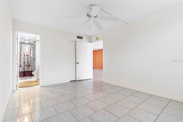 empty room featuring ceiling fan and light tile patterned floors