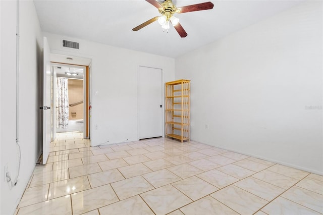 2650 Pearce Dr Unit 403, Clearwater, FL 33764 - unfurnished bedroom featuring a ceiling fan and light tile patterned floors