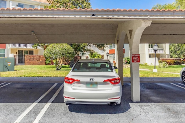 view of vehicle parking with a yard